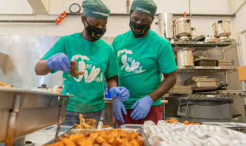 two chefs preparing food with the text Just Veggiez on their shirts