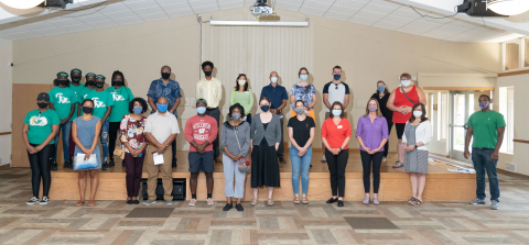 group of people standing in a socially distanced group