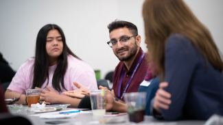 scientists talking with high school-aged student