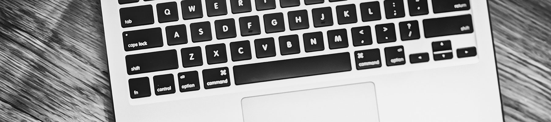 black and white photo of a laptop keyboard