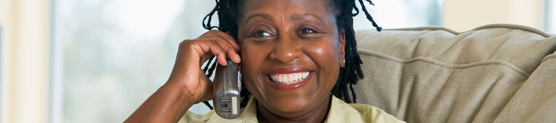 woman on couch talking on phone