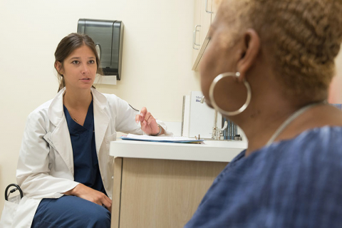 doctor speaking with patient in office