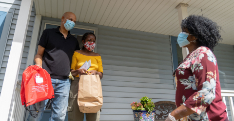 woman delivering food to couple