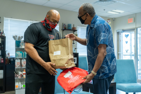 man delivering food to another man