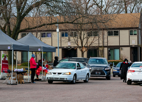 a group of cars at a drive-through healthy aging resource fair