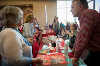 staff and members of the public talking at a resource fair