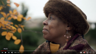 profile photo of woman wearing a winter hat in a garden