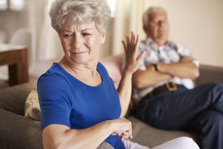 woman visibly upset with man sitting on couch next to her