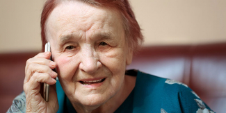 elderly woman talking on cell phone