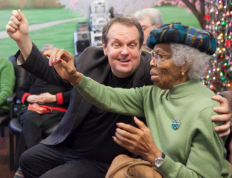 man and woman with arms extended during a poetry reading