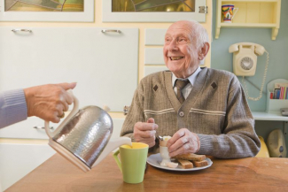 elderly man eating breakfast