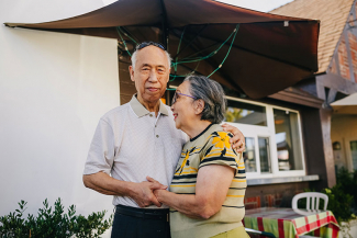 senior couple embracing in an outdoor cafe setting