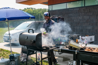 man cooking at outdoor grill