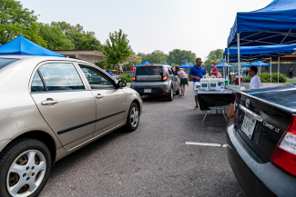 cars driving through outdoor resource fair