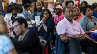 Volunteers seated at an appreciation event