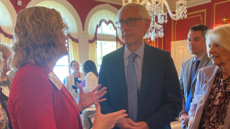 Dr. Cynthia Carlsson talking with Governor Tony Evers and First Lady Kathy Evers