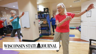 A photo of two older women in a workout class. The Wisconsin State Journal logo is in the bottom left corner