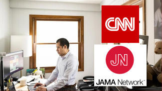 Dr. Nathaniel Chin works at his office. On the right, the logos for CNN and JAMA Network are  featured on the photo of Chin working.
