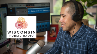 Nathaniel Chin, MD, at his desk with the Wisconsin Public Radio logo on his computer