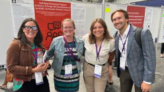 Drs. Carey Gleason and Beth Planalp and Lexi Nelson and Nick Schulz take a photo in front of a scientific poster at the Alzheimer's Association International Conference