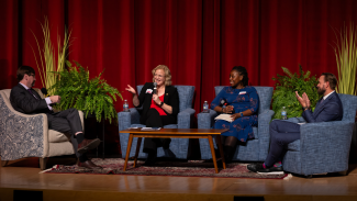 Drs. Art Walaszek, Cynthia Carlsson, Shenikqua Bouges, and Jack Temple sit around a table talking on stage at the 2023 Fall Community Conversation