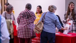 Guests walk around a healthy aging resource fair at the 2023 Fall Community Conversation