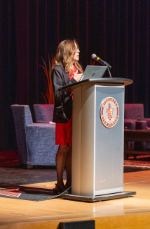 Dr. Kimberly Mueller speaking at the podium