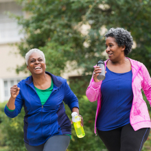 two women power walking