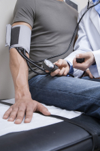 doctor checking blood pressure on patient