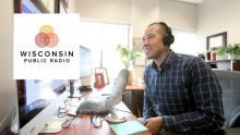 Nathaniel Chin, MD, at his desk with the Wisconsin Public Radio logo on his computer