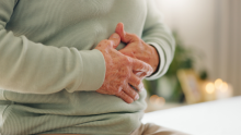 A photo of a person holding their stomach