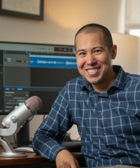 portrait of Dr. Nathaniel Chin at his podcasting desk